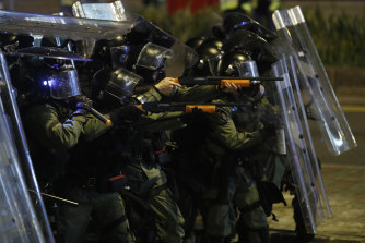 Riot police officer point weapons during a confrontation with protesters in Hong Kong on Sunday.