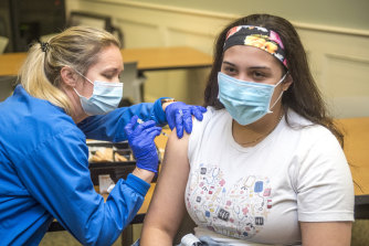 Registered nurse Betty Hallman gives her colleague Norma Elizondo the Pfizer-BioNTech COVID-19 vaccine at University Hospital in Augusta, Georgia in the US.
