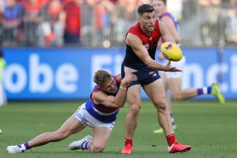 Adam Treloar tackles Jack Viney.