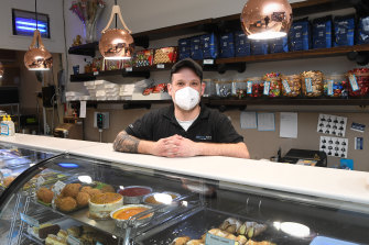 Frank Andacic of Pasticceria Podova in Fawkner, one of the suburbs that will return to lockdown, wears a mask.