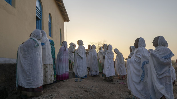 Orthodox Christian Tigrayan refugees who fled the conflict pray in front of a church at Hamdeyat Transition Centre in Sudan near the Ethiopian border.