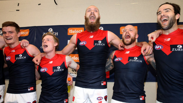 On song: Melbourne players belt out the club song after a breakthrough win over West Coast to secure a top-eight finish.