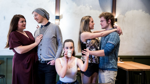 <i>Cosi fan tutte</i>: Left to right- Fiordiligi (Keren Dalzell) and Fernando (Andrew Barrow) are together with Dorabella (Clare Hedley) and Guglieilmo (Nathanael Patterson) on the right while Despina (Katrina Wiseman) busies  herself on her phone and drinking coffee on the job.