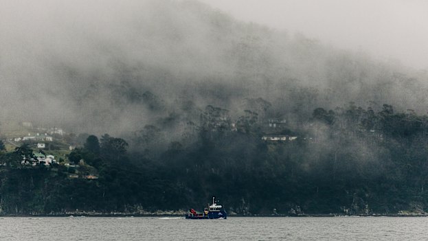A Huon Aquaculture boat travels up the D’Entrecasteaux Channel, which locals say is polluted by effluent from fish farms.