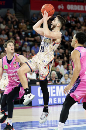 Ben Ayre of the Taipans aims for the basket.