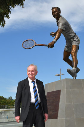 Australian tennis legend Rod Laver stands proudly alongside his statue at Melbourne Park.