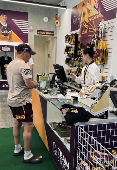 Kevin Walters buys his own Broncos merchandise on Tuesday
