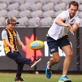 Luke Hodge has a kick with Cooper in his Hawthorn days.