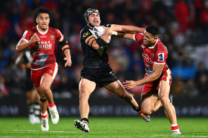 New Zealand halfback Jahrome Hughes makes a break against Tonga.