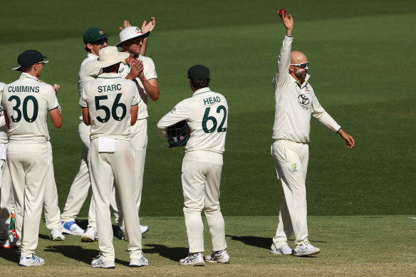 Nathan Lyon’s Australian teammates salute the spinner after his 500th Test scalp.