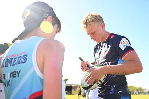 Melbourne Rebels star Carter Gordon signs an autograph on Saturday.