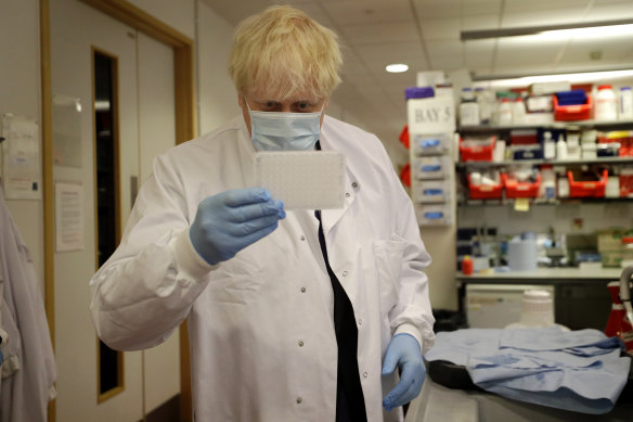 Britain's Prime Minister, Boris Johnson pictured during a visit to a vaccine lab in Oxford, has announced heavy new fines for COVID rule-breakers. 