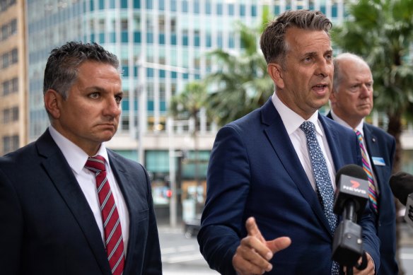 Transport Minister Andrew Constance is joined by the CEO of Sydney Trains Howard Collins, at right, and the NRMA's Peter Khoury in announcing upgrades to the M4 on Monday.