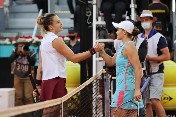 Aryna Sabalenka shakes with Ashleigh Barty following the final in Madrid.