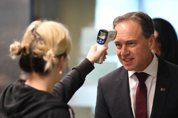 Federal Health Minister Greg Hunt has his temperature checked before touring the Royal Melbourne Hospital on Thursday