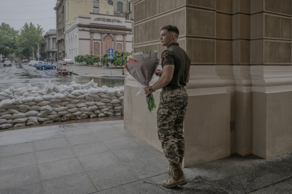 A Ukrainian soldier waits at the entrance to the 212-year-old Opera Theater.