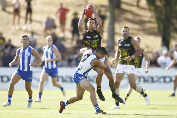 Tim Taranto is tackled by Luke Davies-Uniacke.