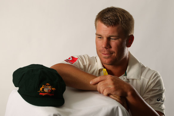 David Warner lovingly eyes a baggy green ahead of his 2011 Test debut.