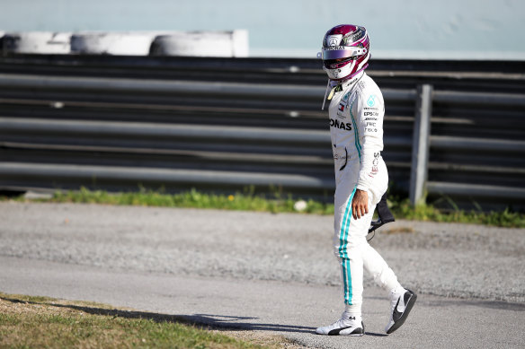 Lewis Hamilton walks back to the pits after car trouble in pre-season testing in Barcelona.