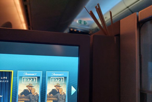 The entertainment system, with drink stirrers shoved into the hinge to keep it in place.