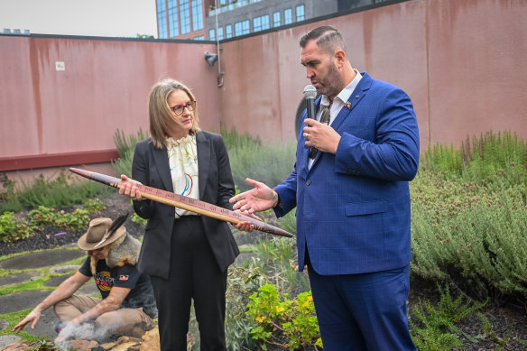 Commissioner Travis Lovett presents  Premier Jacinta Allan with a message stick on Monday that symbolises the history of colonisation in Victoria and hopes for healing through truth telling and a treaty.