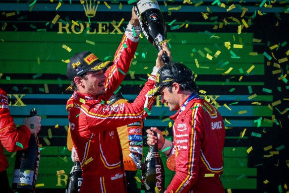 Ferrari teammates Carlos Sainz and Charles Lecler celebrate on the podium.