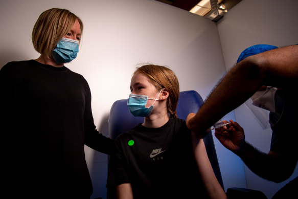 Twelve-year-old Eve, accompanied by her mum Narelle, having his first coronavirus vaccination at the Heidelberg Repatriation Hospital