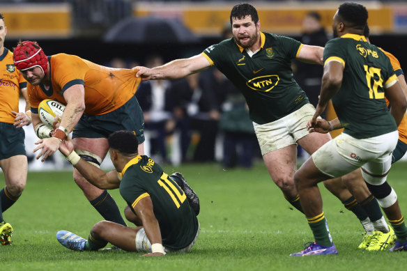 Australia’s Harry Wilson, left, is grabbed by South Africa’s Marco van Staden.