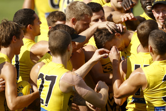 Josh Gibcus is mobbed by teammates after Damien Hardwick announced he would debut against the Blues.