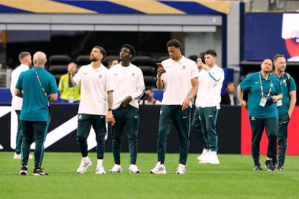 Australia players and staff have a walkthrough on the pitch.