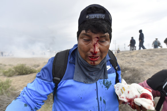 People aid a man injured during anti-government protests Arequipa, Peru.