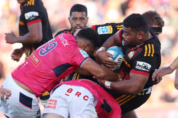 Samisoni Taukei’aho of the Chiefs is tackled by the Rebels.