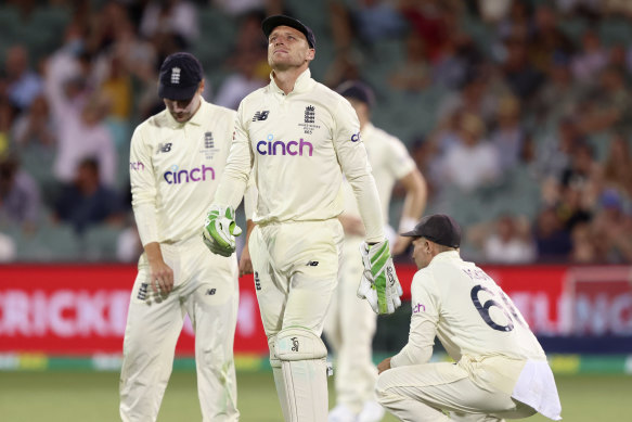 England’s Jos Buttler, centre, looks up after dropping a catching chance against Marnus Labuschagne. 