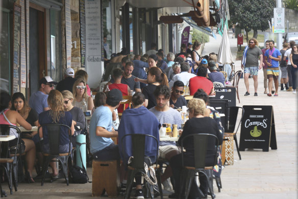 Patrons enjoy the cafes at Bronte Beach on a busy Sunday.