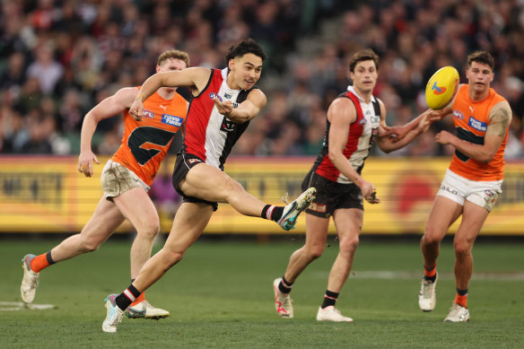 Mitch Owens kicks the ball forward at the MCG.