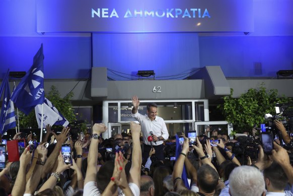Kyriakos Mitsotakis, leader of the center-right New Democracy Party, waves to supporters in front of the party's headquarters in Athens.