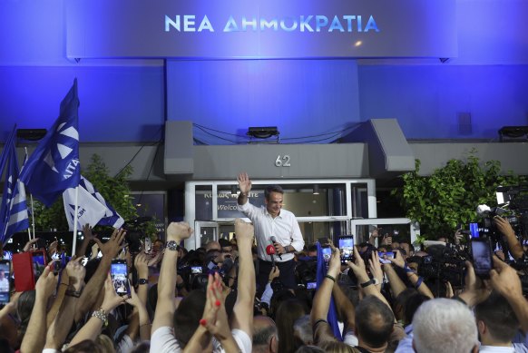 Kyriakos Mitsotakis leader of the centre-right New Democracy waves to supporters outside the headquarters of the party in Athens.