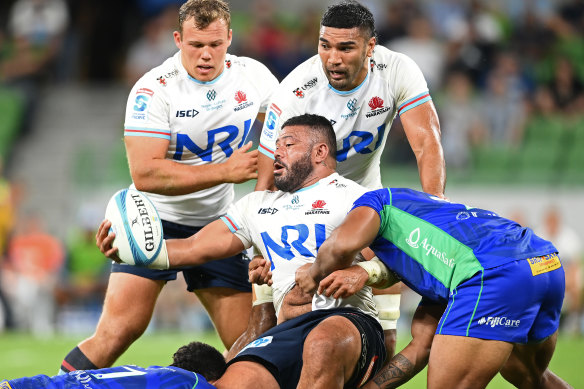 Tolu Latu passes the ball playing against the Drua.