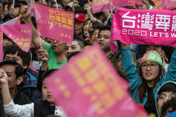 Democratic Progressive Party supporters waved placards as they awaited the results of Saturday's election.