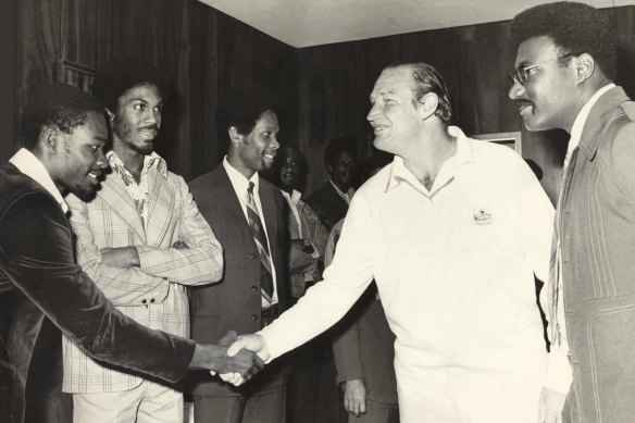 Kerry Packer meets the West Indies cricket team, among them Clive Lloyd to his left and opposite him with his arms folded, Michael Holding, as World Series Cricket gets going in 1977.