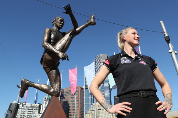 Harris poses with her statue in Melbourne's Federation Square. She knew the abuse would continue after it was unveiled. 