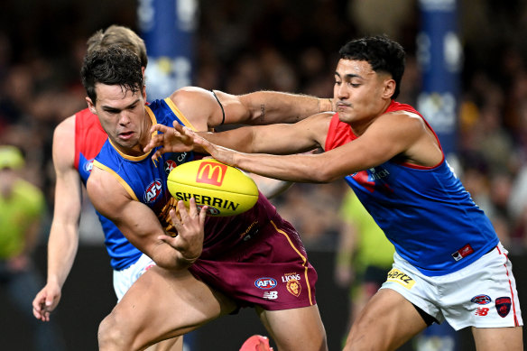 Cam Rayner of the Lions is challenged by Andy Moniz-Wakefield of the Demons.