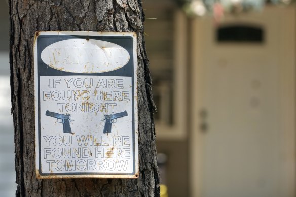 A warning sign outside the home where a mass shooting occurred on Friday night, in Cleveland, Texas. 