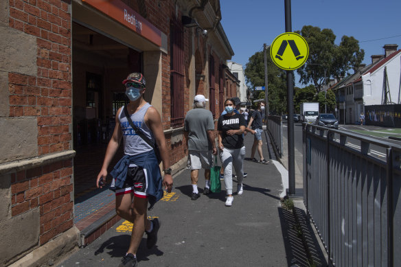 Sydneysiders wearing masks outside Redfern Station.