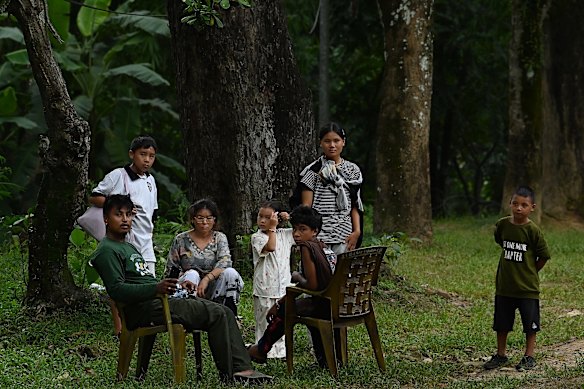 A displaced family waits for evacuation.