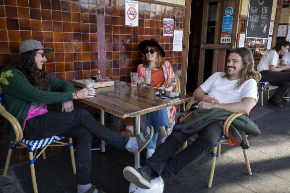 Locals drink at tables outside the Bells Hotel in Woolloomooloo during warm weather.