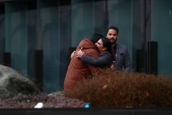 Victims of the Christchurch mosque shootings arrive at the Justice Precinct for the accused terrorist’s High Court hearing in 2020.  Pictured: Linwood mosque hero Abdul Aziz hugs a friend outside court.