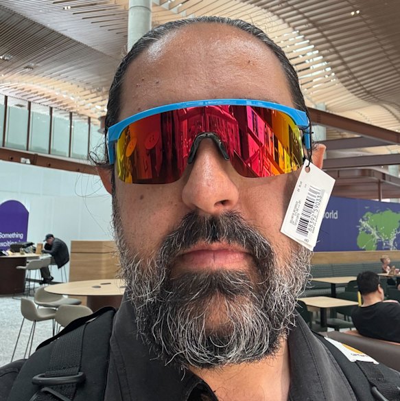 The rainbow reflection: Mostafa Rachwani tries multiple sunglasses at the airport kiosk.