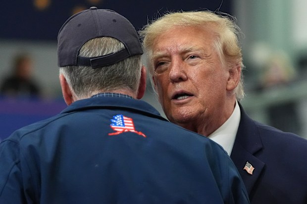 President Donald Trump talks with Sen. Dan Sullivan at a campaign event earlier this month.