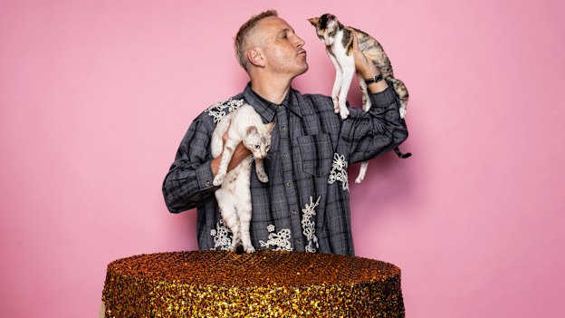 Internationally-renowned cat judge Steven Meserve holding a Seal lynx tabby point, Snow, left, and Scilly Rex Sage a Cornish Rex. 